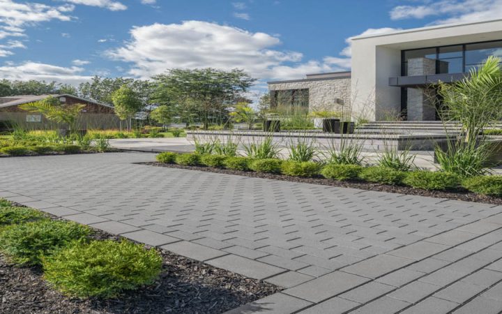 A spacious concrete terrace overlooking a serene waterfront, showcasing expert masonry and concrete work.