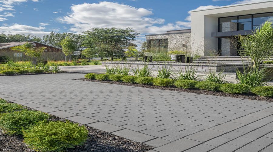 A spacious concrete terrace overlooking a serene waterfront, showcasing expert masonry and concrete work.