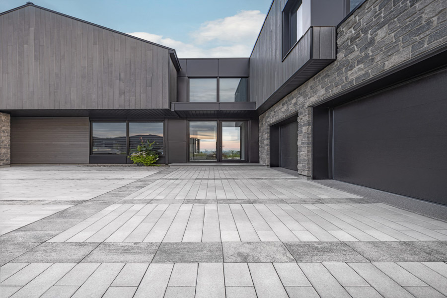 A sleek and modern concrete driveway with precise lines, enhancing the architectural beauty of a contemporary home.