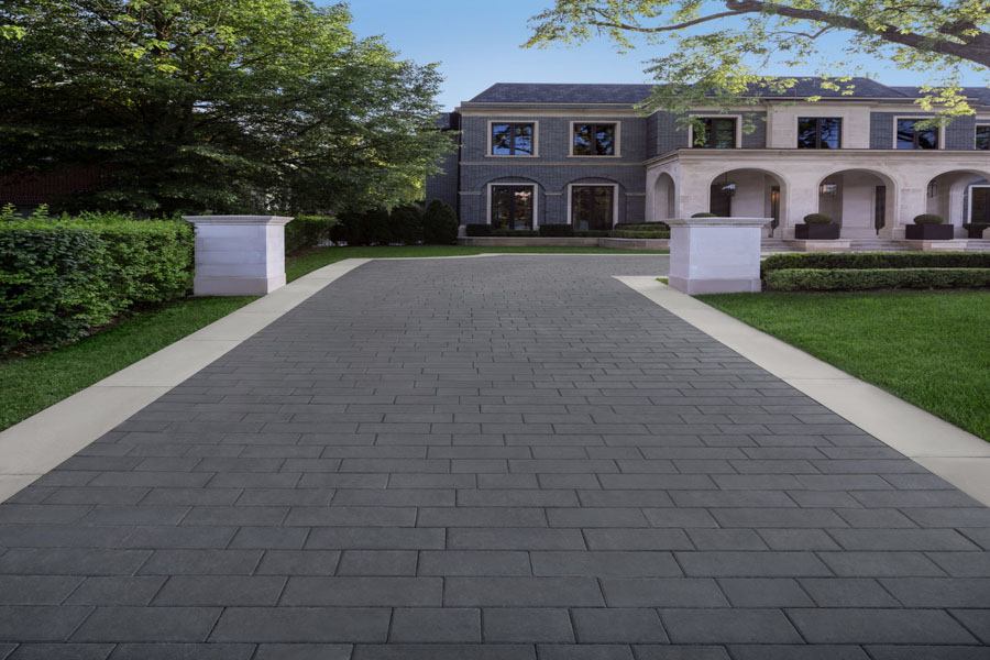 A contemporary driveway design using precast concrete pavers, offering durability and aesthetic appeal for residential properties.