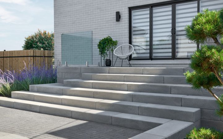 Clean and modern concrete steps leading to an outdoor patio, blending functionality with style.