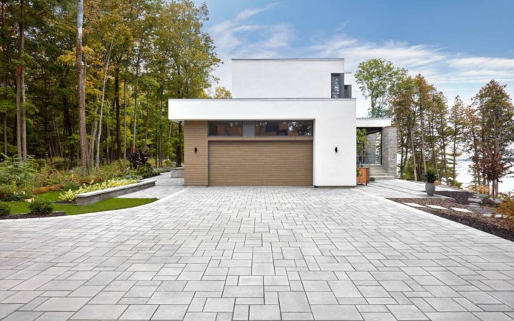 A sleek driveway featuring interlocking concrete pavers, offering durability and a contemporary design.