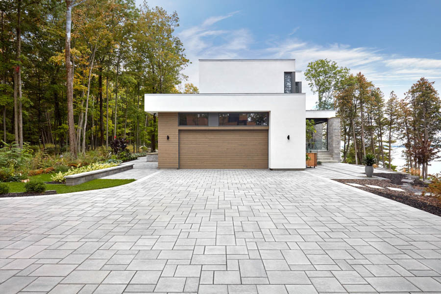 A sleek driveway featuring interlocking concrete pavers, offering durability and a contemporary design.