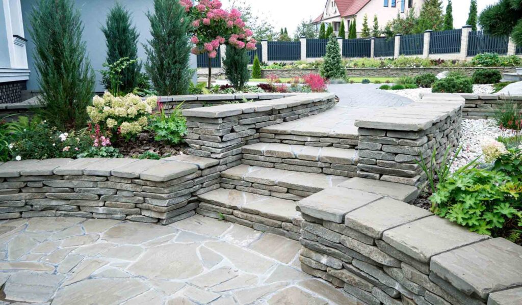 Elegant stone pathway leading through a beautifully landscaped garden, surrounded by lush plants and ambient lighting.